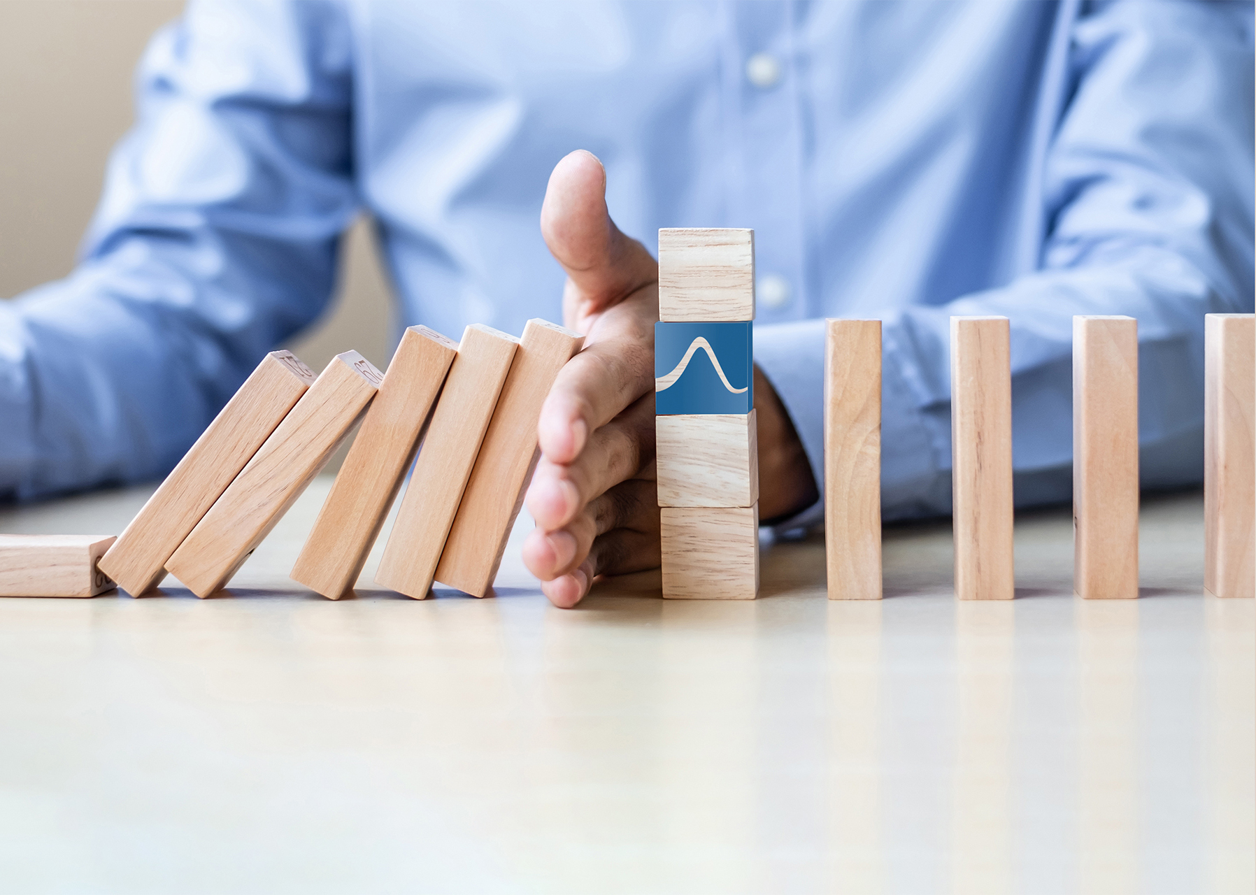 Businessman hand Stopping Falling wooden Blocks or Dominoes. Bus